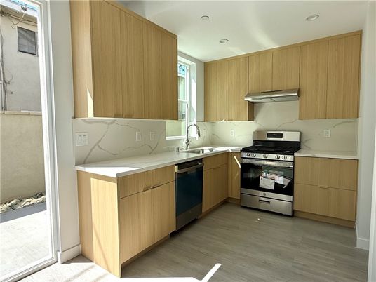 Interior, Kitchen, Marble Walls, Recessed Lighting, Stainless Steel Appliances, Wood Texture Flooring