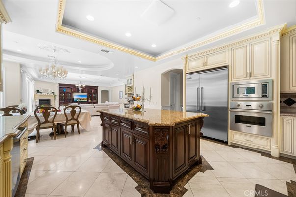 Chandelier, Dining room, Fireplace, Interior, Kitchen, Living room, Recessed Lighting, Stainless Steel Appliances