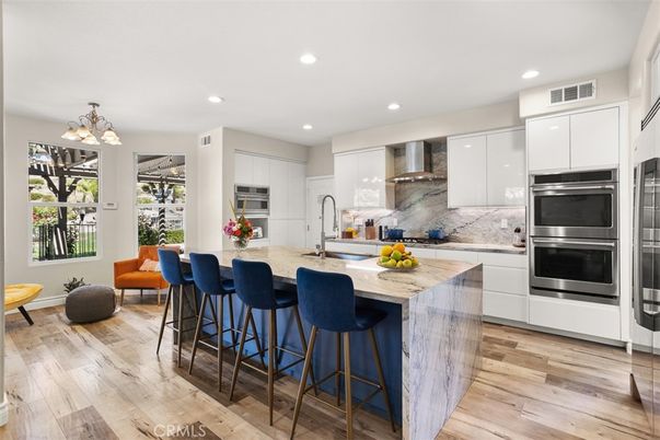 Interior, Kitchen, Marble Walls, Recessed Lighting, Stainless Steel Appliances, Wood Texture Flooring