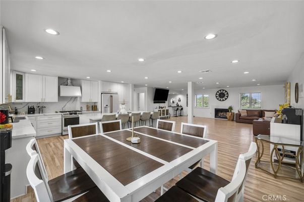 Dining room, Fireplace, Interior, Kitchen, Living room, Recessed Lighting, Stainless Steel Appliances, Wood Texture Flooring