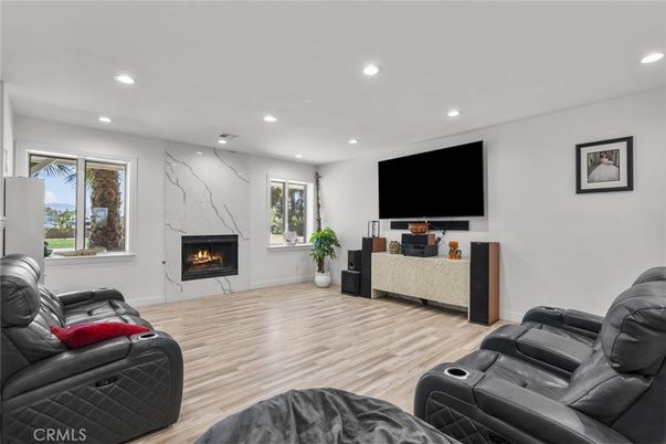 Home Theatre Room, Fireplace, Interior, Living room, Marble Walls, Recessed Lighting, Wood Texture Flooring
