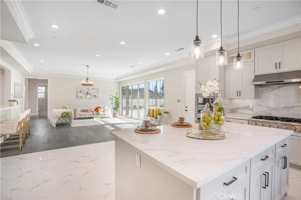 Chandelier, Interior, Kitchen, Marble Walls, Pendant Lights, Recessed Lighting, Stainless Steel Appliances, Wood Texture Flooring
