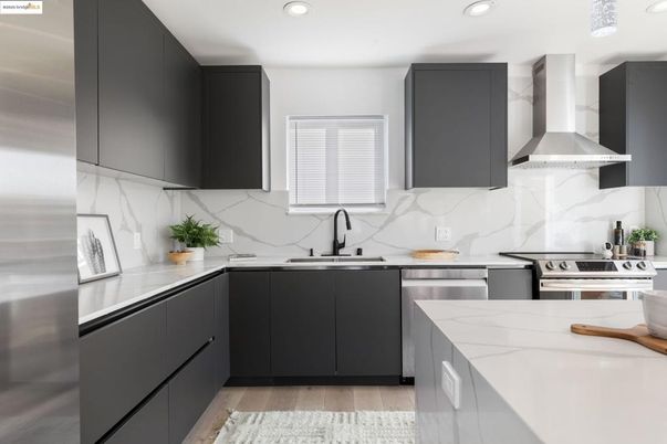 Interior, Kitchen, Marble Walls, Recessed Lighting, Stainless Steel Appliances, Wood Texture Flooring