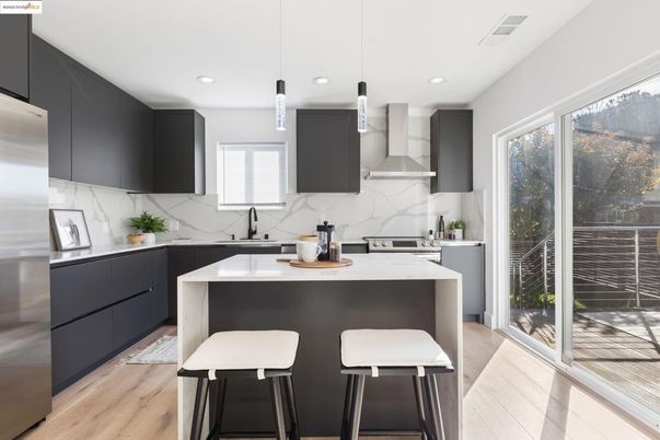 Interior, Kitchen, Marble Walls, Pendant Lights, Recessed Lighting, Stainless Steel Appliances, Wood Texture Flooring