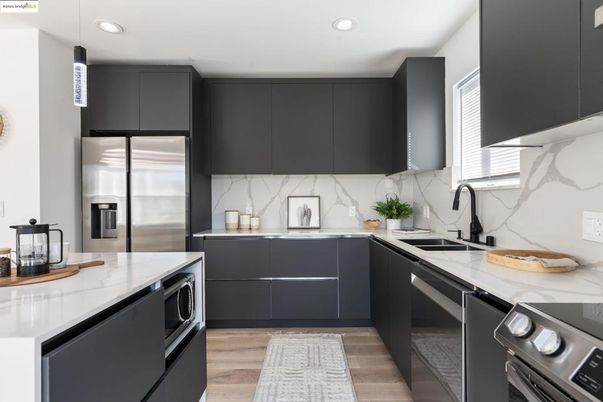 Interior, Kitchen, Marble Walls, Recessed Lighting, Stainless Steel Appliances, Wood Texture Flooring