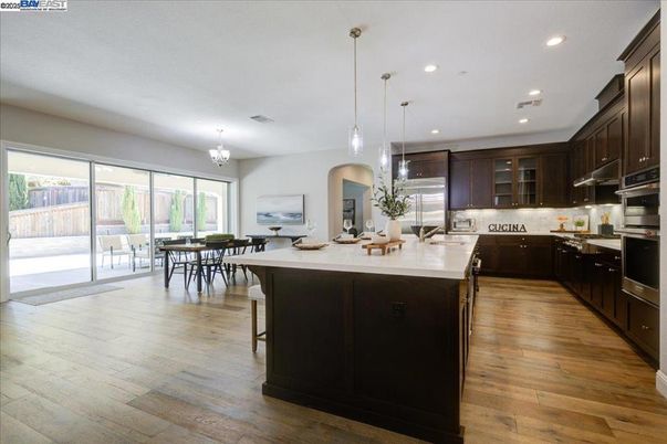 Chandelier, Dining room, Interior, Kitchen, Pendant Lights, Recessed Lighting, Stainless Steel Appliances, Wood Texture Flooring