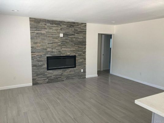 Empty room, Fireplace, Interior, Recessed Lighting, Stone Walls, Wood Texture Flooring