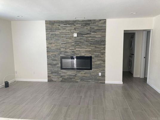 Empty room, Fireplace, Interior, Recessed Lighting, Stone Walls, Wood Texture Flooring