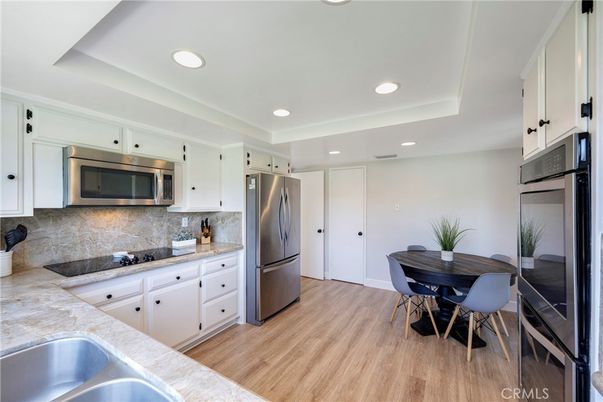 Dining room, Interior, Kitchen, Recessed Lighting, Stainless Steel Appliances, Wood Texture Flooring