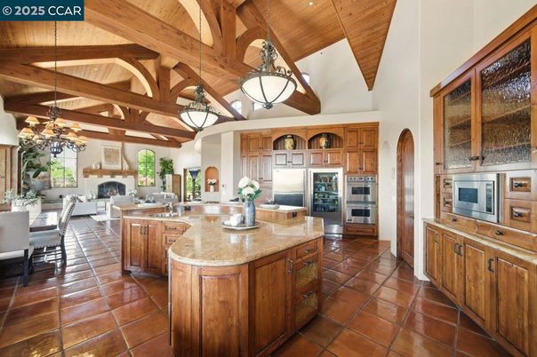 Chandelier, Dining room, Fireplace, Interior, Kitchen, Living room, Pendant Lights, Stainless Steel Appliances, Wooden Beams, Wooden Ceilings