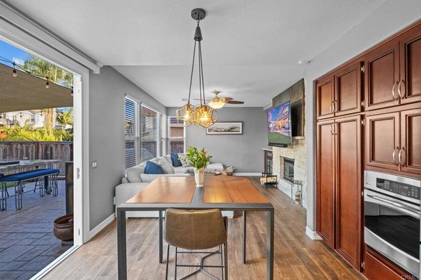 Dining room, Fireplace, Interior, Kitchen, Pendant Lights, Stainless Steel Appliances, Wood Texture Flooring