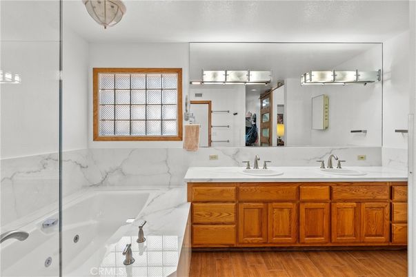 Bathroom, Dual Sink Vanities, Interior, Marble Walls, Wood Texture Flooring