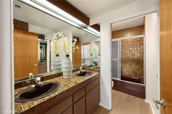Bathroom, Dual Sink Vanities, Glass Shower, Interior, Tile Countertops, Wood Texture Flooring
