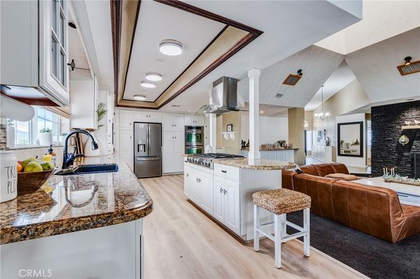 Fireplace, Interior, Kitchen, Living room, Pendant Lights, Recessed Lighting, Stainless Steel Appliances, Stone Walls, Wood Texture Flooring