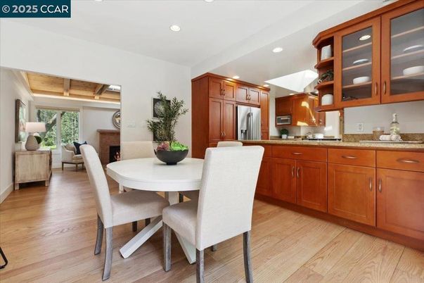Dining room, Fireplace, Interior, Kitchen, Recessed Lighting, Stainless Steel Appliances, Wood Texture Flooring