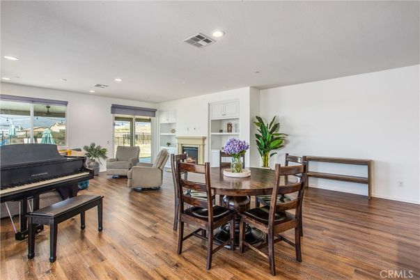 Dining room, Fireplace, Interior, Living room, Piano, Recessed Lighting, Wood Texture Flooring