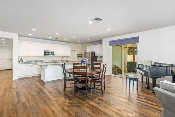Dining room, Interior, Kitchen, Piano, Recessed Lighting, Stainless Steel Appliances, Wood Texture Flooring