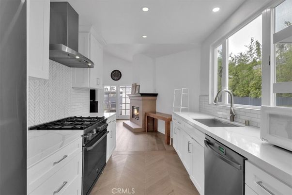 Fireplace, Interior, Kitchen, Recessed Lighting, Stainless Steel Appliances, Wood Texture Flooring