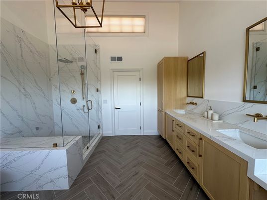 Bathroom, Dual Sink Vanities, Glass Shower, Interior, Marble Walls, Wood Texture Flooring