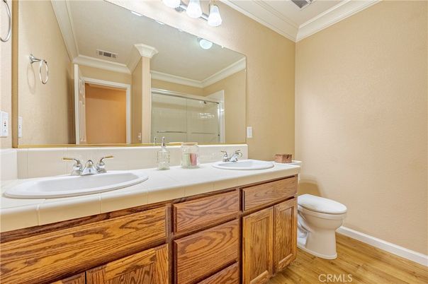 Bathroom, Dual Sink Vanities, Glass Shower, Interior, Tile Countertops, Wood Texture Flooring