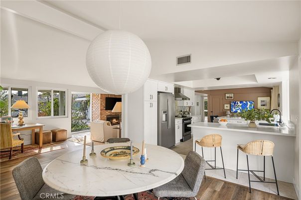 Dining room, Fireplace, Interior, Kitchen, Pendant Lights, Stainless Steel Appliances, Wood Texture Flooring