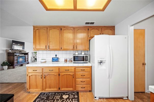 Fireplace, Interior, Kitchen, Tile Countertops, Wood Texture Flooring