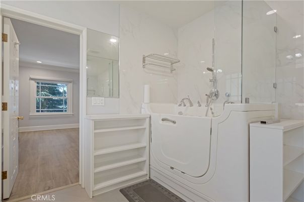 Bathroom, Interior, Marble Walls, Recessed Lighting, Washer, Wood Texture Flooring