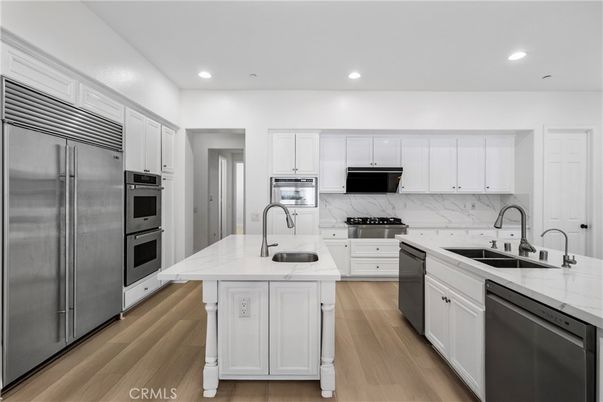 Interior, Kitchen, Marble Walls, Recessed Lighting, Stainless Steel Appliances, Wood Texture Flooring