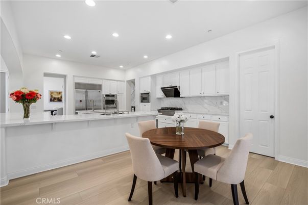 Dining room, Interior, Kitchen, Marble Walls, Recessed Lighting, Stainless Steel Appliances, Wood Texture Flooring