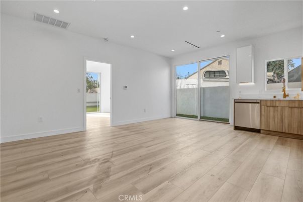 Empty room, Interior, Kitchen, Recessed Lighting, Stainless Steel Appliances, Wood Texture Flooring