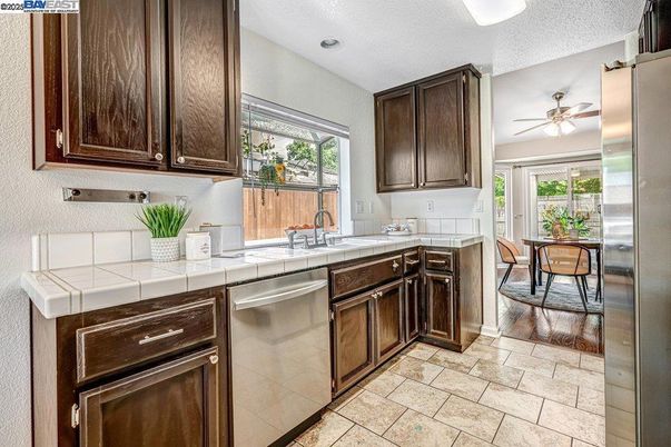 Dining room, Interior, Kitchen, Recessed Lighting, Stainless Steel Appliances, Tile Countertops, Wood Texture Flooring