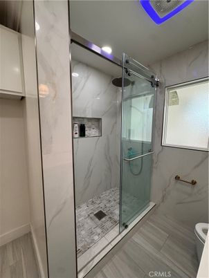 Bathroom, Glass Shower, Interior, Marble Walls, Recessed Lighting, Wood Texture Flooring