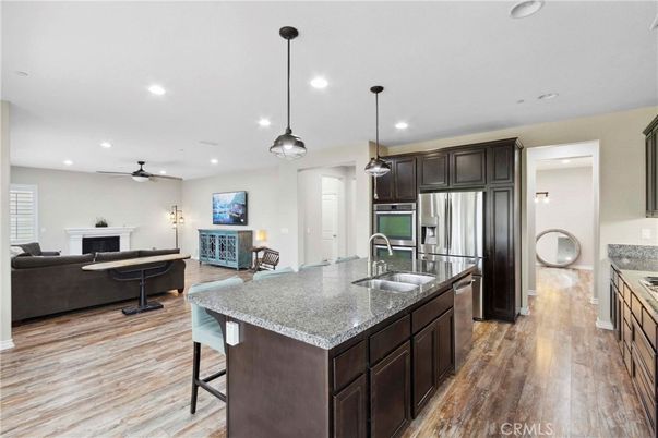 Fireplace, Interior, Kitchen, Living room, Pendant Lights, Recessed Lighting, Stainless Steel Appliances, Wood Texture Flooring