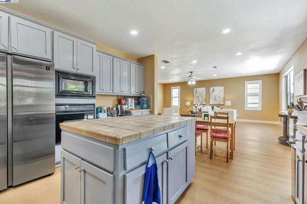 Dining room, Interior, Kitchen, Recessed Lighting, Stainless Steel Appliances, Tile Countertops, Wood Texture Flooring