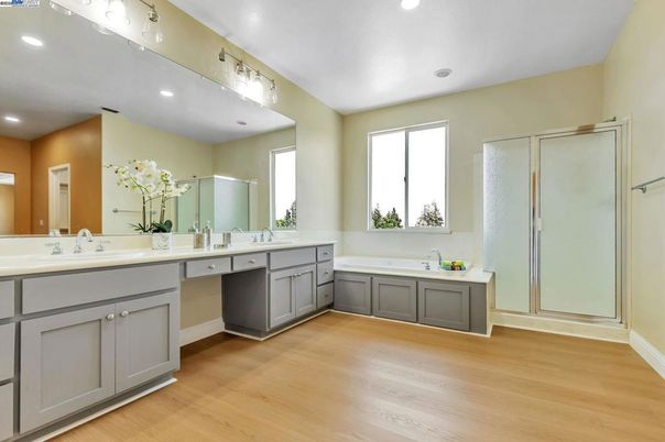 Bathroom, Dual Sink Vanities, Glass Shower, Interior, Recessed Lighting, Wood Texture Flooring