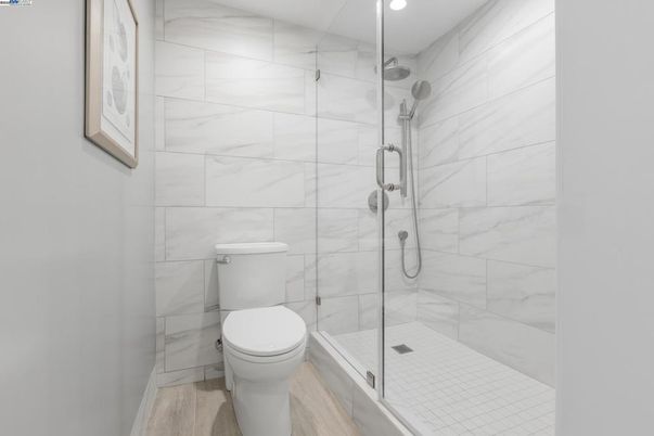 Bathroom, Glass Shower, Interior, Marble Walls, Recessed Lighting, Wood Texture Flooring