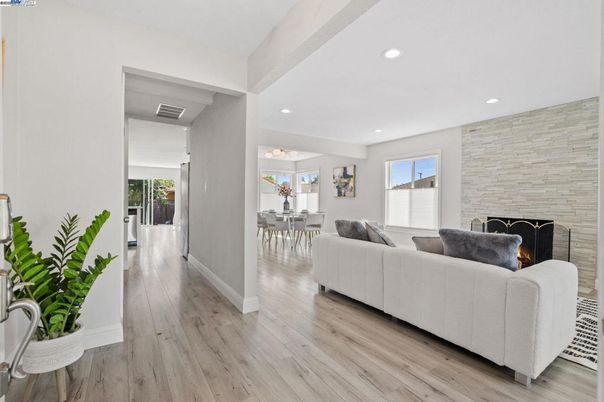 Dining room, Fireplace, Interior, Living room, Recessed Lighting, Stone Walls, Wood Texture Flooring
