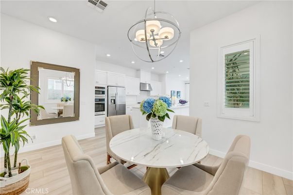 Chandelier, Dining room, Interior, Kitchen, Pendant Lights, Recessed Lighting, Stainless Steel Appliances, Wood Texture Flooring
