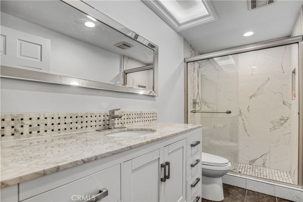 Bathroom, Dual Sink Vanities, Glass Shower, Interior, Marble Walls, Recessed Lighting