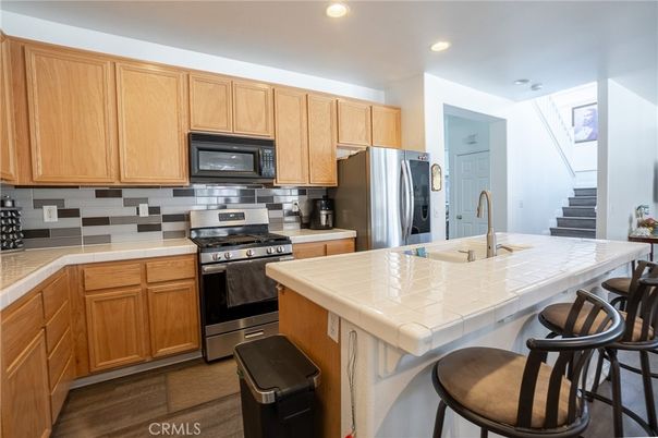 Interior, Kitchen, Recessed Lighting, Stainless Steel Appliances, Tile Countertops, Wood Texture Flooring