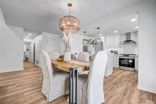 Chandelier, Dining room, Interior, Kitchen, Pendant Lights, Recessed Lighting, Stainless Steel Appliances, Wood Texture Flooring