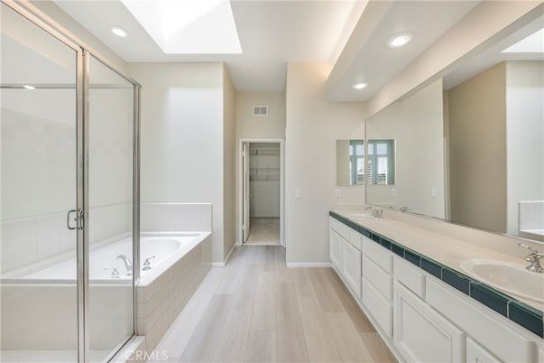 Bathroom, Dual Sink Vanities, Glass Shower, Interior, Recessed Lighting, Tile Countertops, Wood Texture Flooring