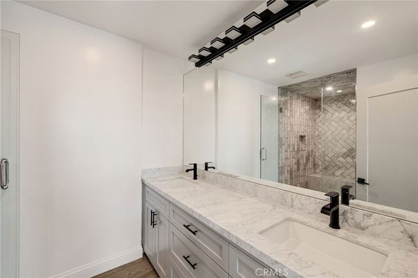 Bathroom, Dual Sink Vanities, Glass Shower, Interior, Recessed Lighting, Wood Texture Flooring
