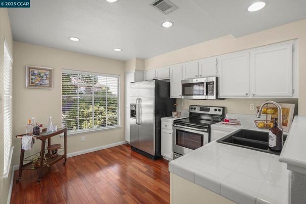Interior, Kitchen, Recessed Lighting, Stainless Steel Appliances, Tile Countertops, Wood Texture Flooring