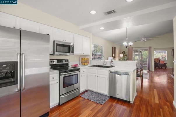 Chandelier, Dining room, Interior, Kitchen, Recessed Lighting, Stainless Steel Appliances, Wood Texture Flooring