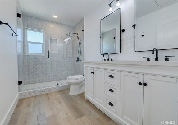 Bathroom, Dual Sink Vanities, Glass Shower, Interior, Recessed Lighting, Wood Texture Flooring