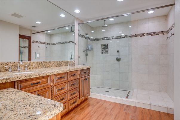 Bathroom, Dual Sink Vanities, Glass Shower, Interior, Recessed Lighting, Wood Texture Flooring