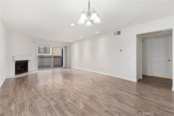 Chandelier, Empty room, Fireplace, Interior, Recessed Lighting, Wood Texture Flooring