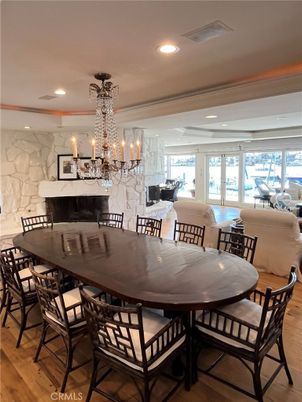 Chandelier, Dining room, Fireplace, Interior, Living room, Marble Walls, Recessed Lighting, Stone Walls, Wood Texture Flooring