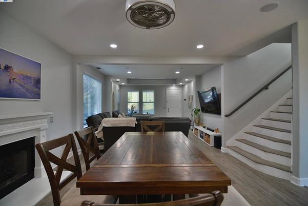 Dining room, Fireplace, Interior, Living room, Recessed Lighting, Wood Texture Flooring
